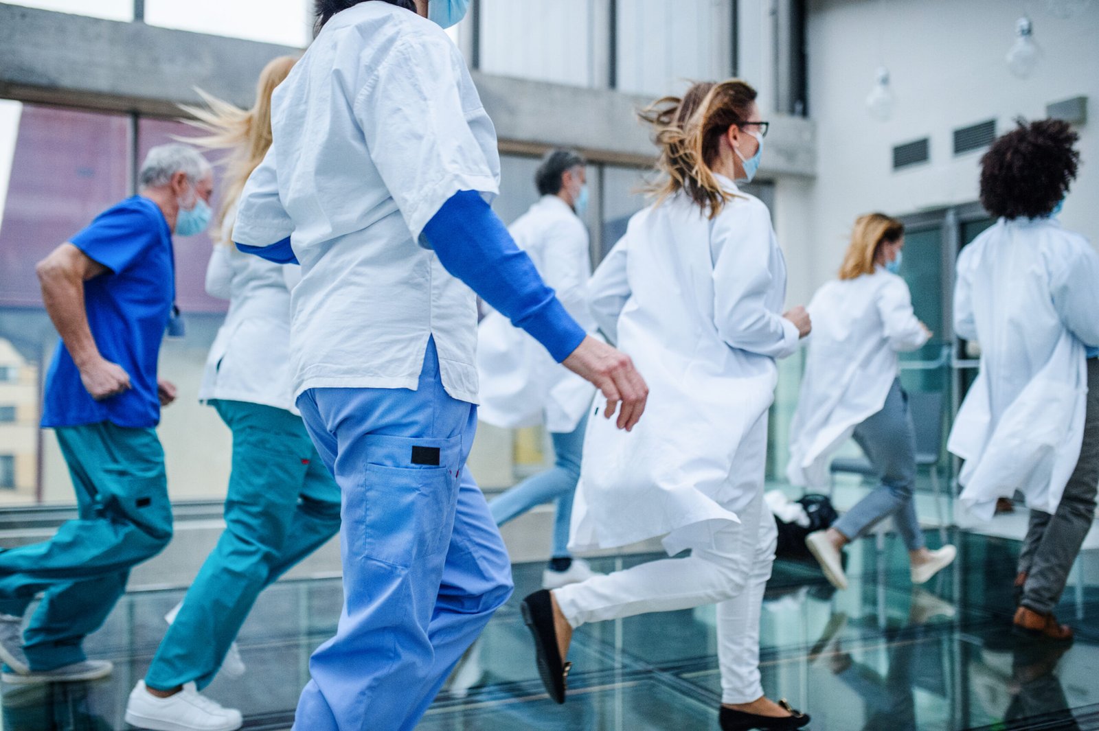 Group of doctors running in a hospital corridor wearing the best daily use insoles — BOUNZE Daily Performance Custom Insole — for all-day support and comfort during emergencies.