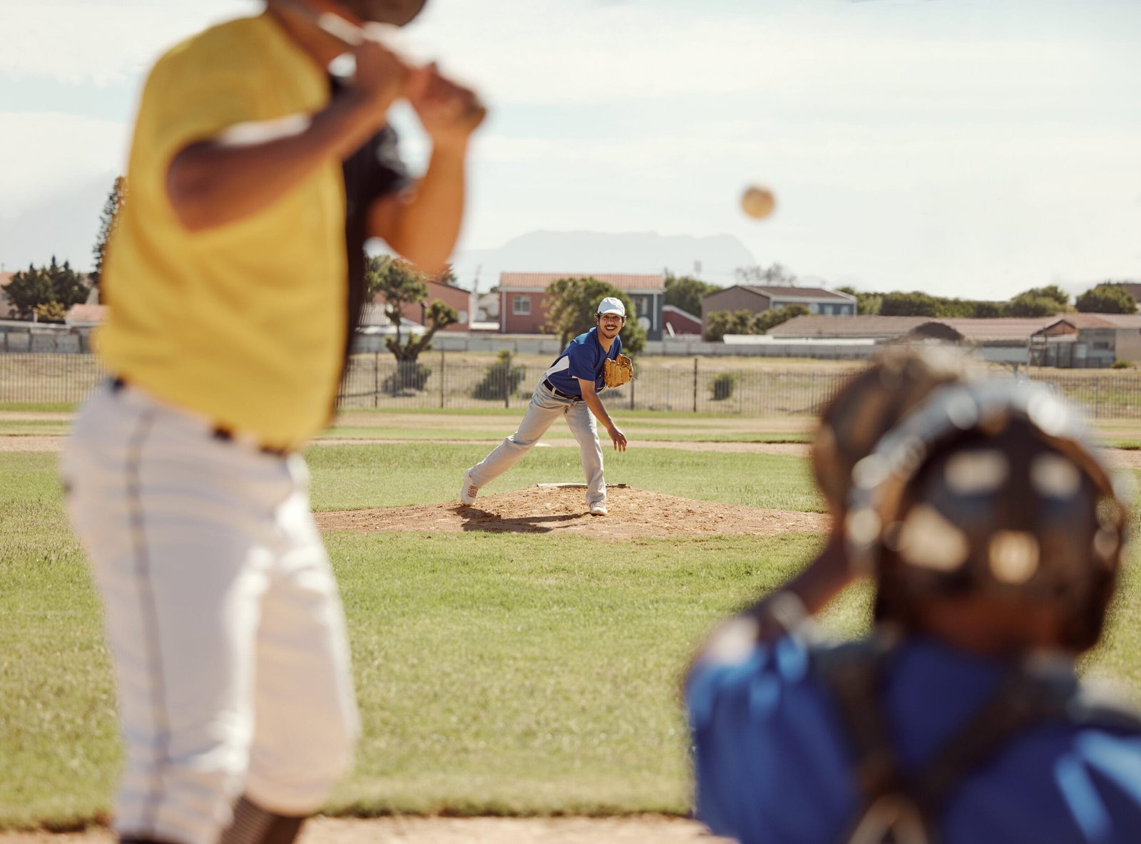 Baseball players in motion highlighting the need for supportive custom insoles in cleats