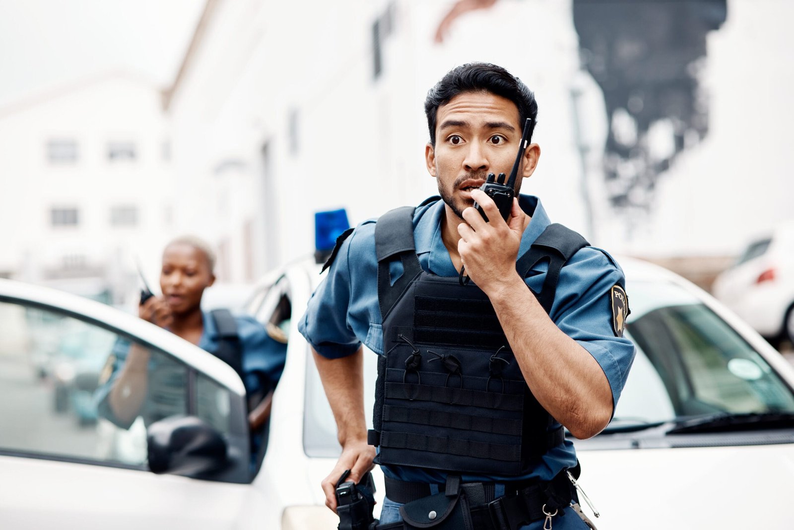 Police officers in action on pavement during a shift, highlighting the need for arch support insoles benefits in action-packed jobs.