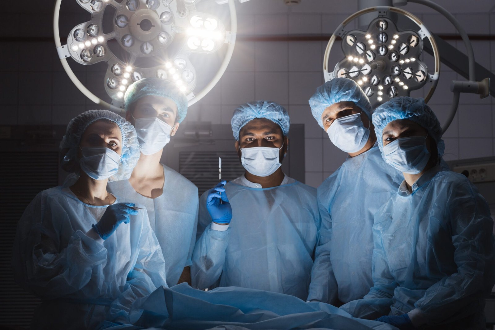 Surgical team in the operating room under bright lights, representing prolonged standing and the need for foot support during long shifts.