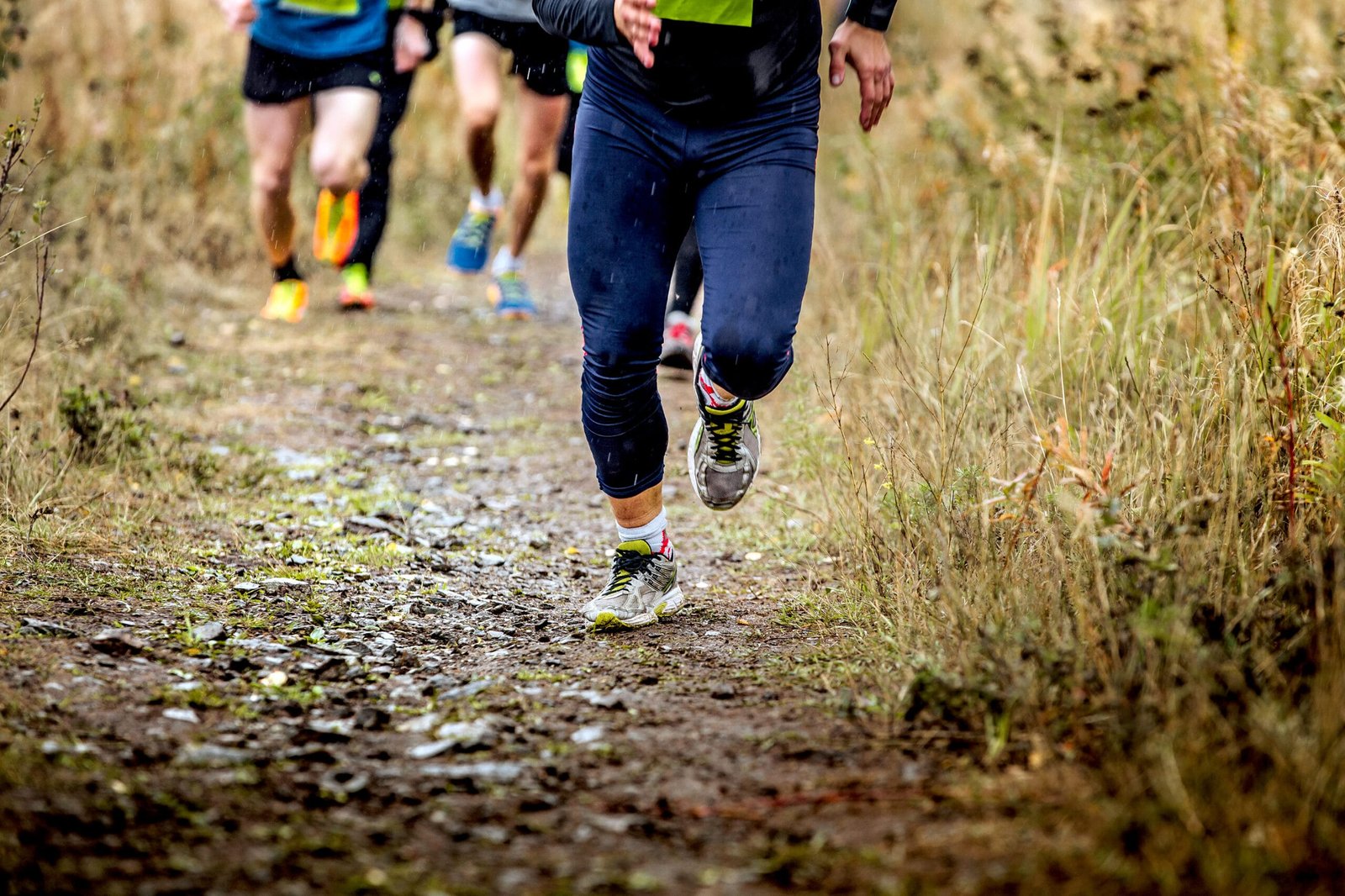 Trail runners navigating muddy terrain—emphasizing the need for custom insoles built for stability